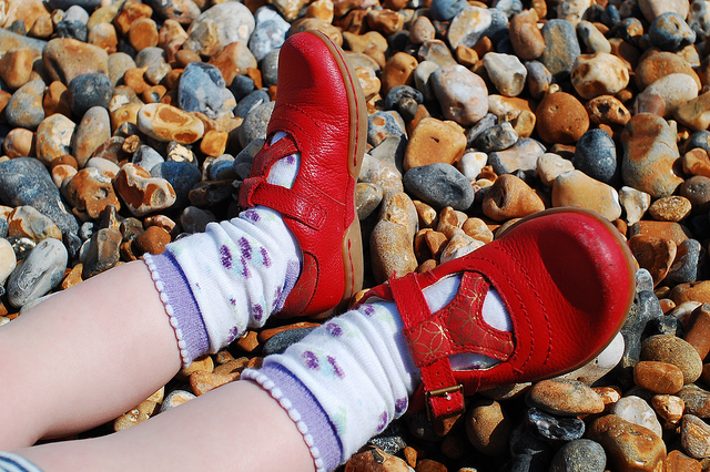 toddler in red shoes