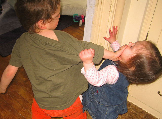 children fighting on playground